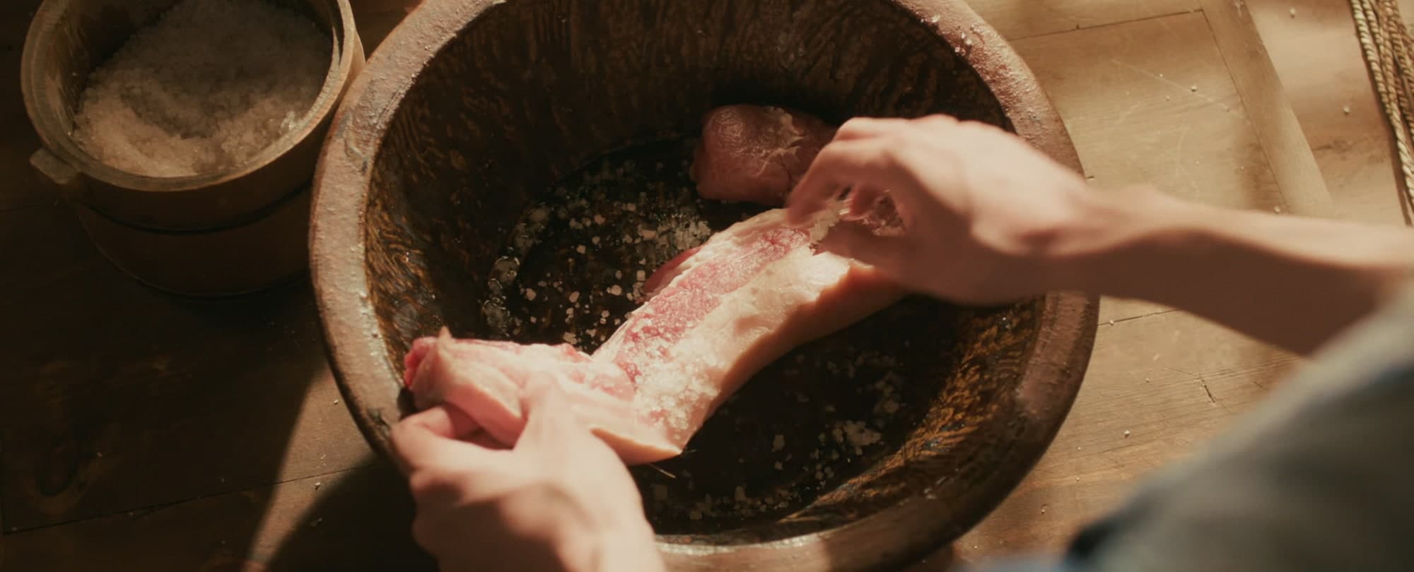 肉に粗塩をすり込む手元